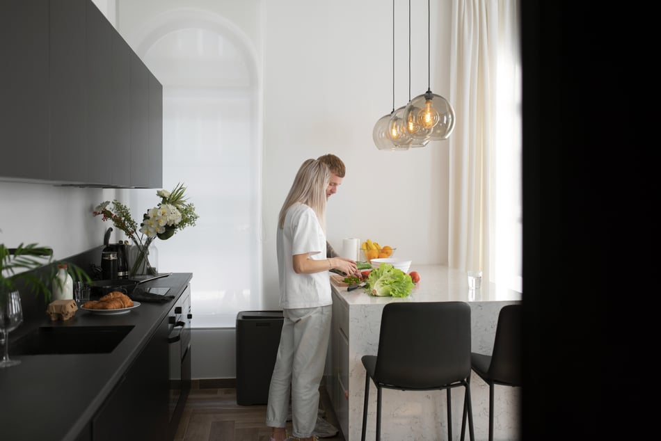 Couple cooking in the kitchen which is decorated with flowers
